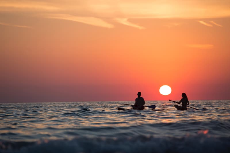 Una pareja haciendo kayak en el mar