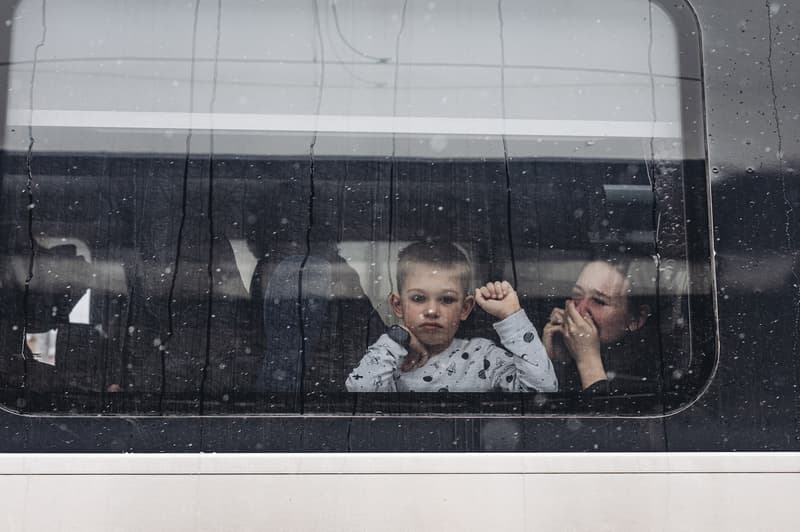 Un nen i la seva mare observen des d'un tren a l'estació de tren de Kíev. Les autoritats d'Ucraïna han denunciat desenes de morts en un atac amb projectils per part de l'Exèrcit de Rússia contra la ciutat de Khàrkiv, la segona més poblada del país, en el marc de la invasió desencadenada el 24 de febrer. En aquest context, centenars de persones s'han llançat a l'estació de tren amb l'objectiu de sortir del país. a 1 de març de 2022, a Kíev (Ucraïna) | Diego Herrera/ Europa Press